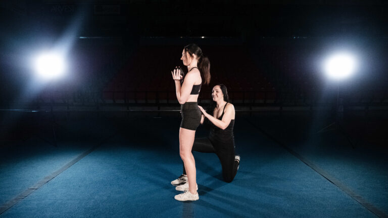 CheerX founder Melinda Paulsell showing a cheerleader how to find neutral pelvis